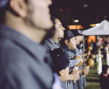 Tataviam tribal members stand in a line at downtown Los Angeles' Grand Park, singing and giving a blessing at the 2016 L.A. Pow Wow.