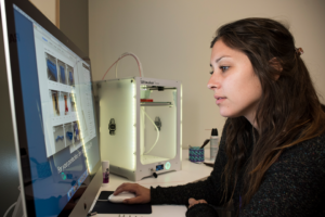 A student works on a Mac computer in the Creative Media Studio, located inside the CSUN University Library.