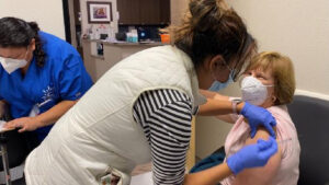 CSUN alumna Terri Stratton, ’78 (Health Science), MPH ’85 (Public Health), receives the COVID-19 vaccination.
