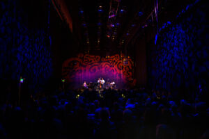 The Branford Marsalis Quartet performs surrounded by tables of concertgoers.