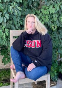 Erika D. Beck in CSUN sweatshirt and jeans.
