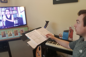 Singer Adam McCrory rehearses with music director Mercedes Juan Musotto onscreen.