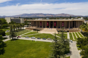 CSUN library with cars lined up on walkway