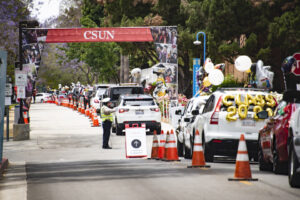 Cars lined up under a CSUN banner