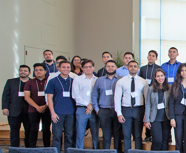 About 40 students pose for a picture smiling.