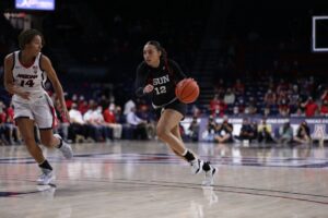 Basketball player running down court.
