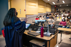 Professor lectures to students wearing medical masks