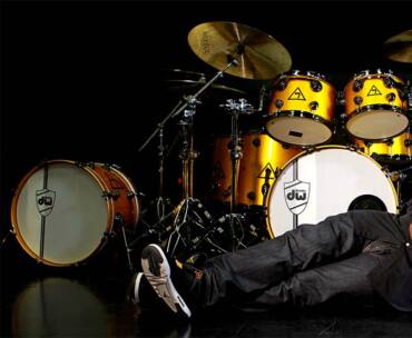 Trevor Lawrence, Jr. lies in front of drum set