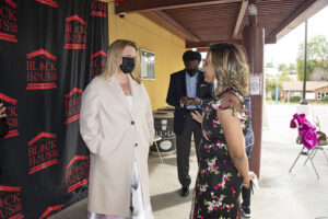 President Erika D. Beck and The Director of The Black House Dominique Moye stand outside the CSUN West Gallery. William Watkins, vice president for Student Affairs and dean of students stands in background