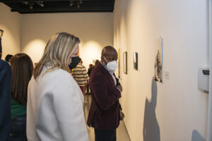 President Erika D. Beck and Dean Yan Searcy admire artwork in West Gallery