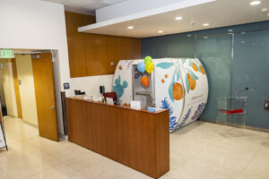 Small white trailer with brightly colored flowers.