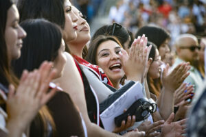 A crowd of new graduates claps and cheers during Honors Convocation 2022.