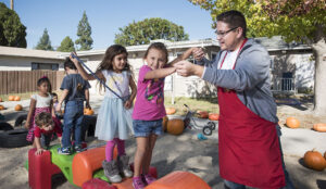 Children standing with teacher.