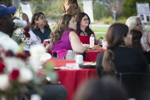 Maria Martinez sitting at table with friends.