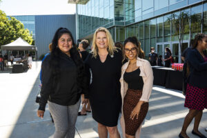 Three women stand together outside The Soraya.