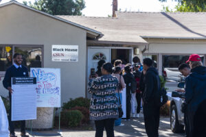 Guests are lined up outside of the entrance of the Black House.