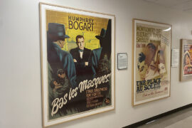 An image captured of two movie posters. One is for 'Bas les Masques,' a Humphrey Bogart Film and one is a poster for 'Une Place Au Soleil,' an Elizabeth Taylor film.