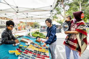 Guests take a look at the fruits at the fresh produce booth.