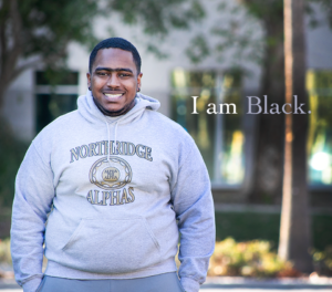 Portrait of student Derrick Lewis with the words "I am Black" on the image.