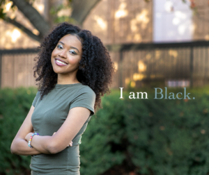 Portrait of student Sable Holt with the words "I am Black" on the image.