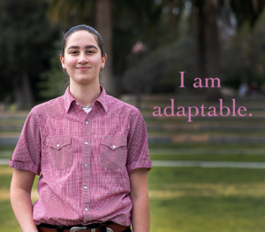 Photo of Katie Karroum looking directly at camera with the text, "I am adaptable" on the image.