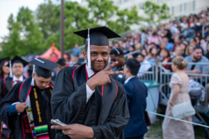 A graduate smiles for the camera