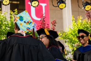 Mortarboard covered in light blue fabric says "Teaching is a Work of Heart."