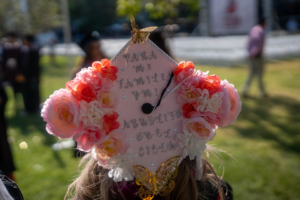Pink flowers and fabric decorate this hand lettered mortarboard