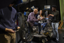 CSUN film professor talking with students in one of the university's film studios.