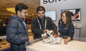 a group of people looking at a robot dog