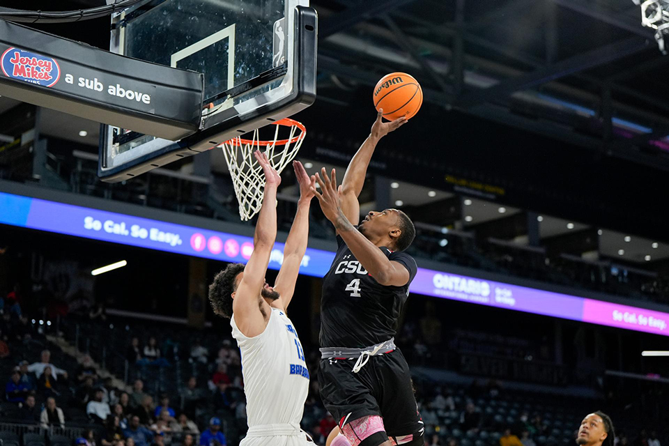 Men's basketball forward Keonte Jones skies over a UCSB player at the basketball.