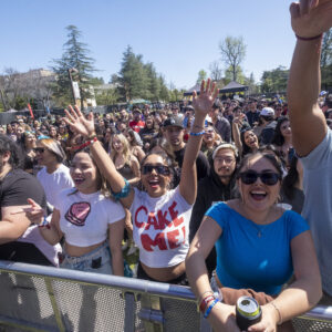 Students cheering at the barricade in the crowd.