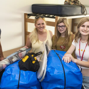 A family poses with their college student moving her into the CSUN dorms.