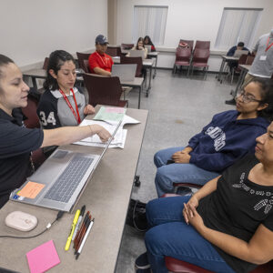 Studenst Melissa Cortez,left,and interpreter Ana Castro, 2nd left, help clients with their tax preparation during the VITA Clinic free tax preparation services at Bookstein Hall on California State University, Northridge in Los Angeles, California, Tuesday, March 19, 2024. (Photo by Ringo Chiu / CSUN)