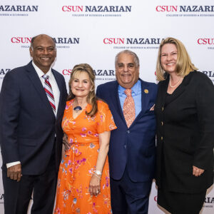 Four people in front of a CSUN Nazarian College step-and-repeat.