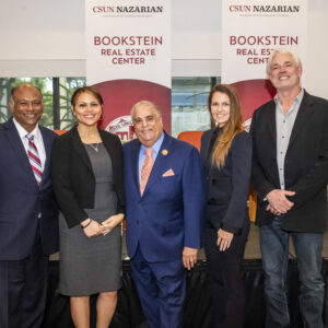 A group photo including a panel of experts who spoke about issues in real estate.