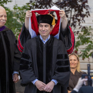 Andrew Anagnost, seated, receives his honorary doctorate degree.
