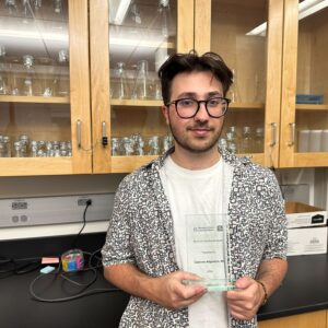 Cameron Atighetchi with award.