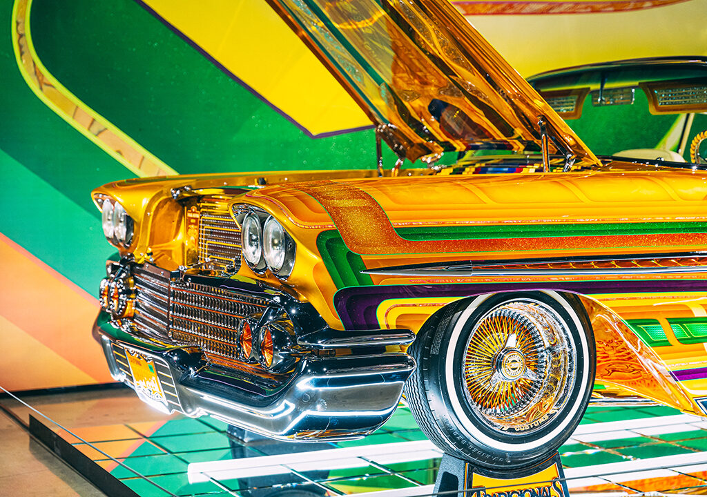 A photo of the front end of 1958 Chevrolet Impala- Final Score, the chassis is gold with yellow, green and red stripes.