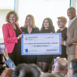 A group photo with a giant check at CSUN.