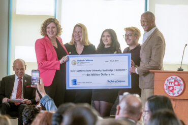 A group photo with a giant check at CSUN.