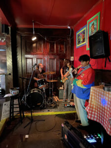 Three CSUN jazz studies students sit in on drums, bass and guitar at a club on Frenchman Street in New Orleans