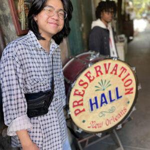 Rising senior AJ Reyes, who plays saxophone, outside the historic Preservation Hall music venue in New Orleans.