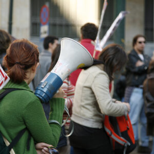 University students waving banners during a march