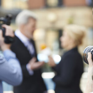 Photographer Taking Pictures Of Female Journalist