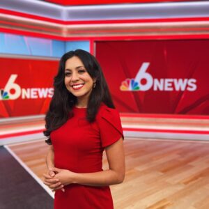 Xochitl Hernandez stands in the NBC 6 News studio, smiling