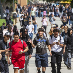 Students crowd the sidewalks on the CSUN campus.