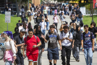 Students crowd the sidewalks on the CSUN campus.