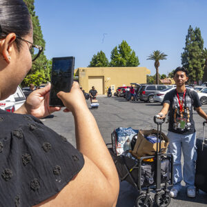 Mom snaps a photo of Jose Garcia, freshman, on move-in day