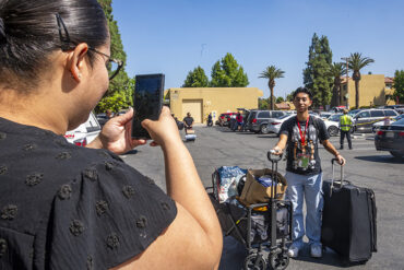 Mom snaps a photo of Jose Garcia, freshman, on move-in day